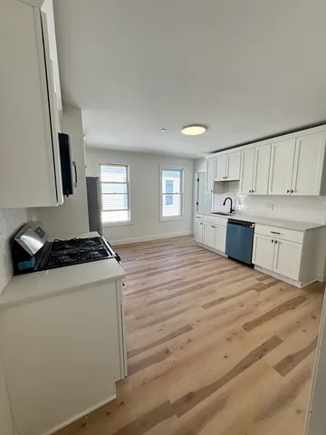 a kitchen with a stove a sink and a refrigerator