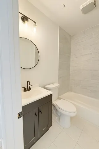 a bathroom with a sink toilet a mirror and vanity
