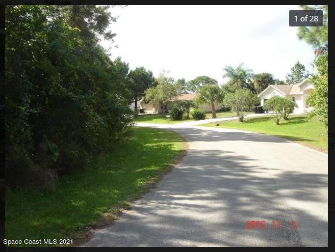 501 Wildmer Road Southwest Palm Bay, FL 32908 - Photo 4 of 12 a view of a yard with palm trees