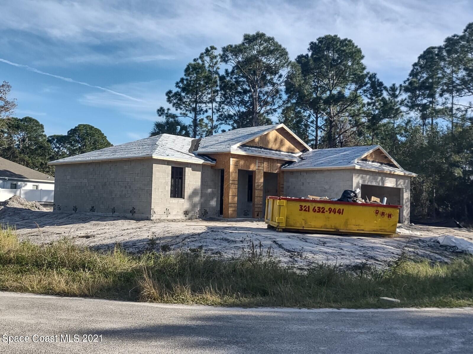 501 Wildmer Road Southwest Palm Bay, FL 32908 - Photo 10 of 12 a front view of a house with a garden