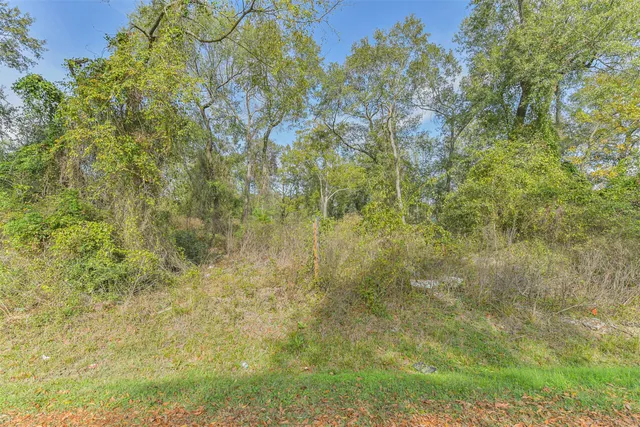 an aerial view of residential house with parking and yard