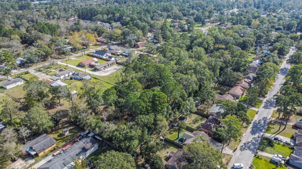 an aerial view of residential house with space and trees all around