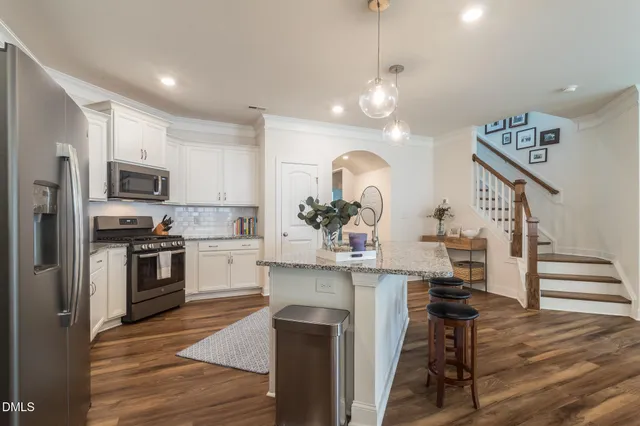 a kitchen with stainless steel appliances kitchen island a large island in the center