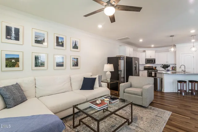 a living room with furniture kitchen view and a table