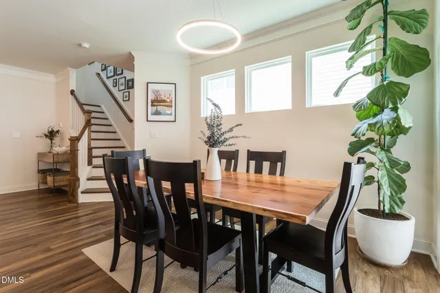a view of a dining room with furniture and wooden floor