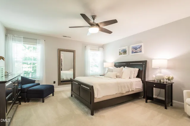 a spacious bedroom with a bed and a couch