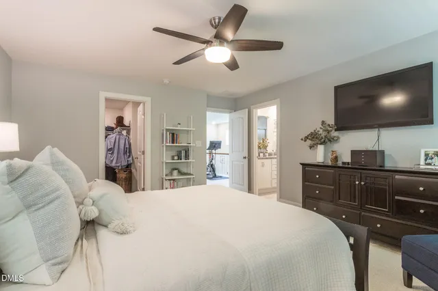 a bedroom with a large bed and a flat screen tv
