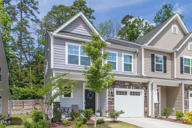 front view of a house with potted plants