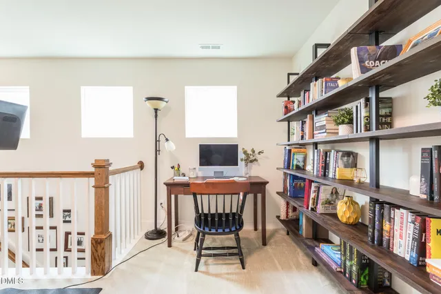 a reading room with furniture and a book shelf