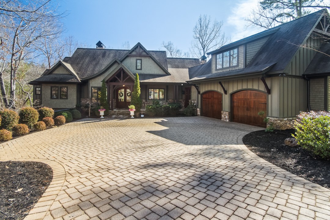 206 Feather Bell Lane Sunset, SC 29685 - Photo 1 of 50 A welcoming Craftsman-style home with timber accents, stone details, and a sweeping paver driveway that sets a refined, private tone from the moment you arrive.