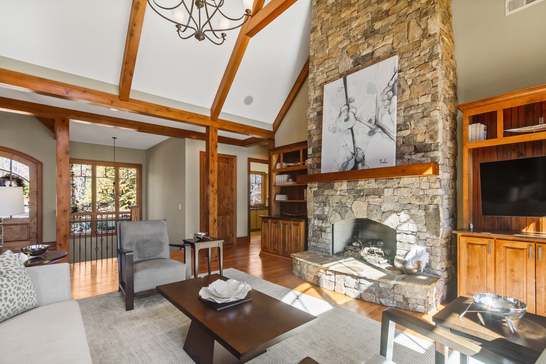 206 Feather Bell Lane Sunset, SC 29685 - Photo 16 of 50 This inviting great room showcases a grand stone fireplace and exposed wood beams.