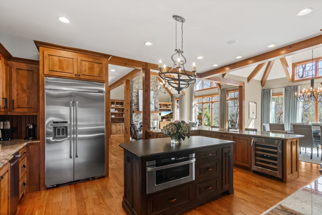206 Feather Bell Lane Sunset, SC 29685 - Photo 8 of 50 The expansive kitchen features gleaming hardwood floors and natural light, creating an ideal space for gatherings.