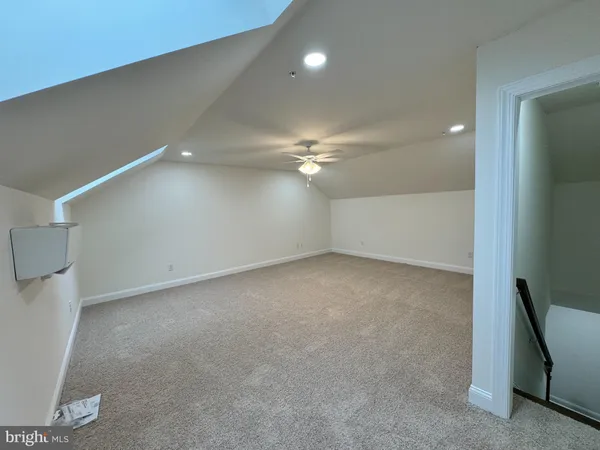 an empty room with an empty space and a ceiling fan