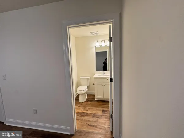 a bathroom with a sink toilet and mirror