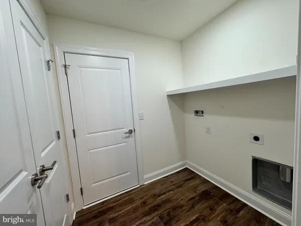 a view of a room with wooden floor and closet area