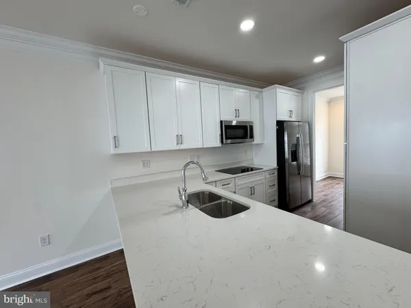 a kitchen with sink stove and cabinets