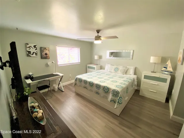 a bedroom with a bed and a tv