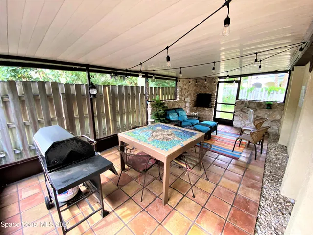 a living room with furniture a rug and a large window