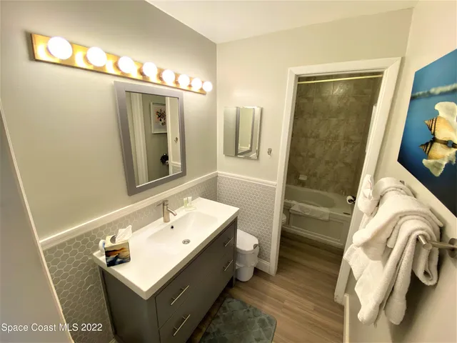 a bathroom with a sink a mirror and a shower