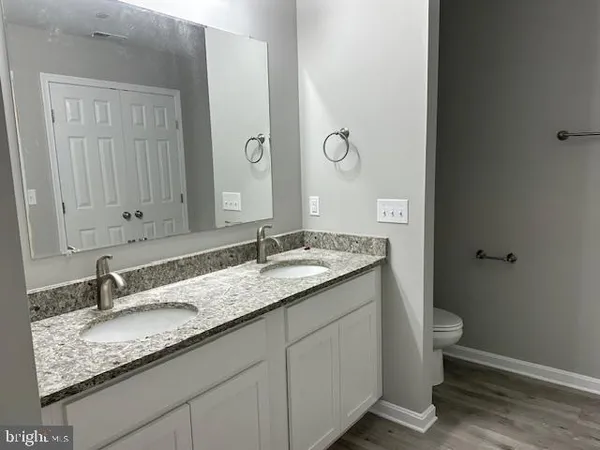 a bathroom with a double vanity sink and mirror