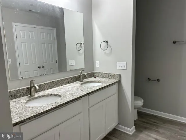 a bathroom with a double vanity sink and mirror