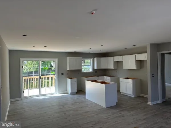 a view of a house with a yard and a tree