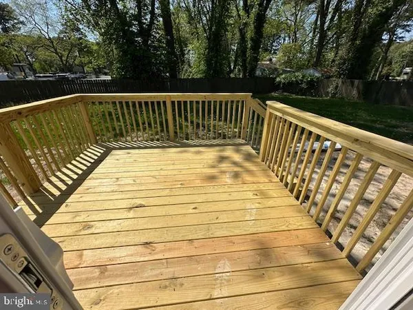 a kitchen with kitchen island wooden floors appliances and cabinets