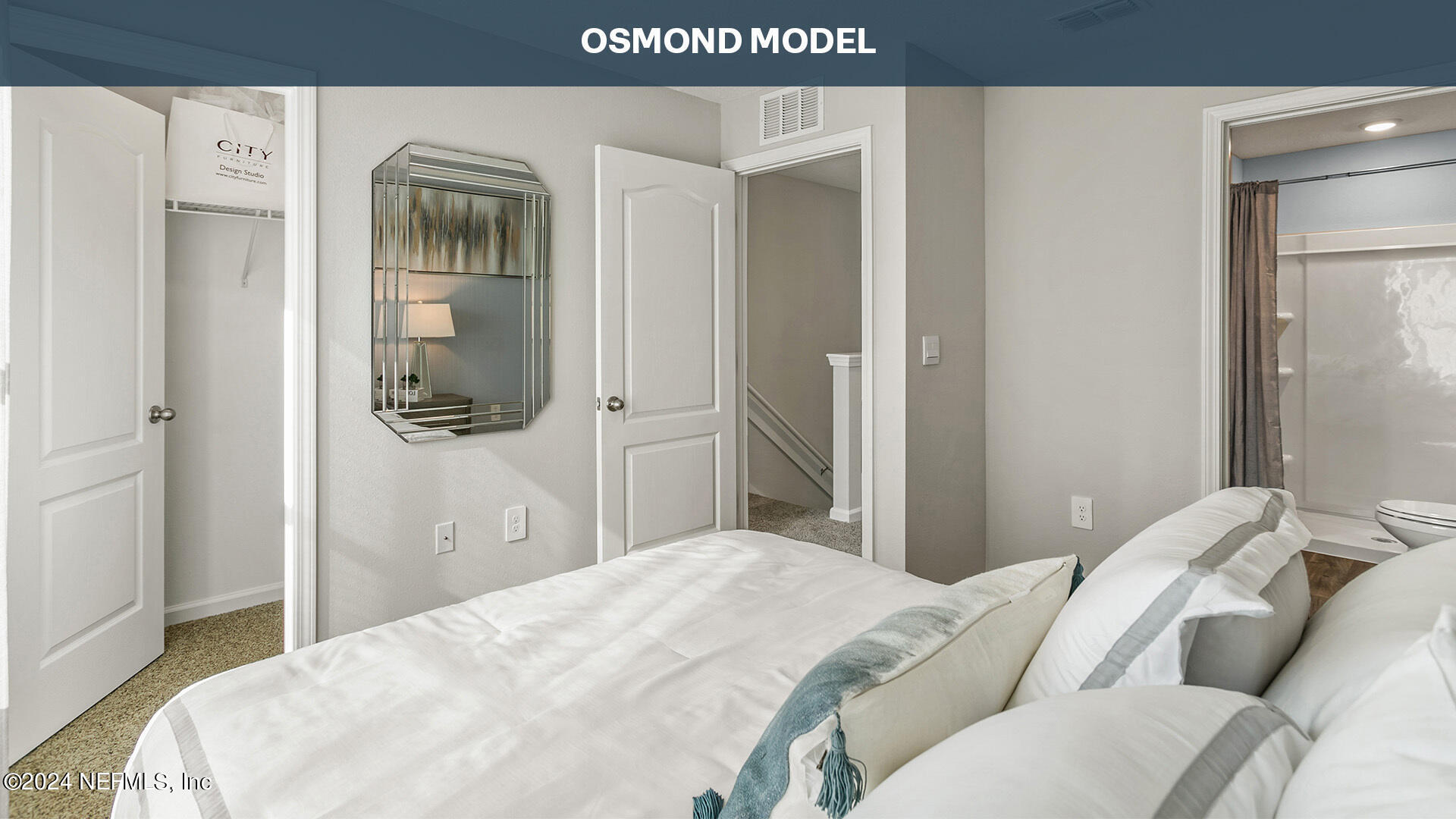 79 Wading Ibis Road St. Augustine, FL 32095 - Photo 15 of 35 a bedroom with a bed and a mirror