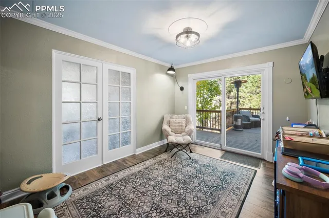 a living room with furniture and baby crib
