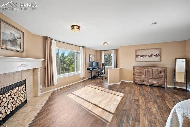 a bedroom with a large bed and a fireplace