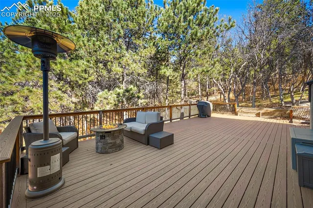 a view of a roof deck with wooden floor and seating space