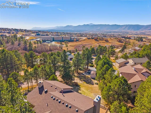 an aerial view of a house with a yard and garden