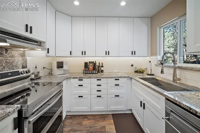 a kitchen with granite countertop a sink and cabinets
