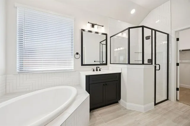 a bathroom with a bathtub sink and mirror