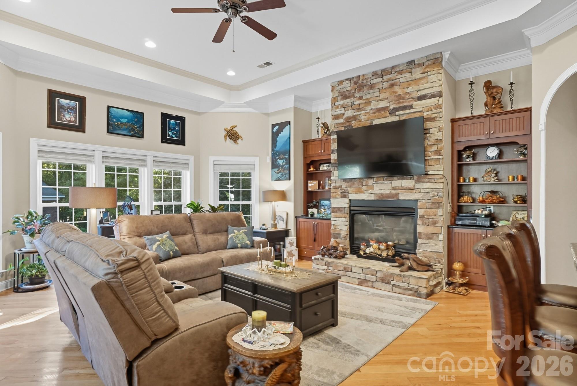 8629 Hayden Way Concord, NC 28025 - Photo 12 of 39 a living room with fireplace furniture and a flat screen tv