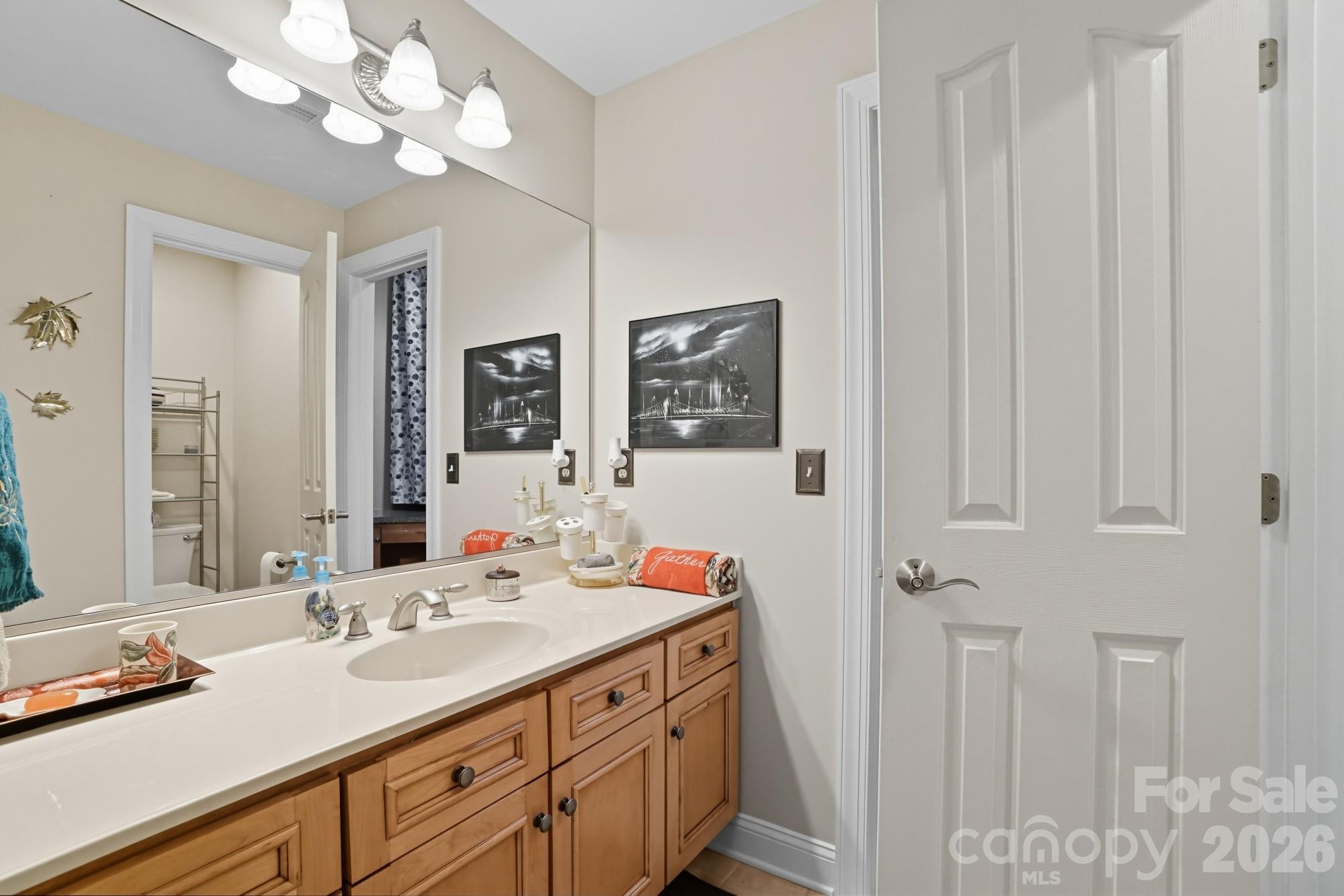 8629 Hayden Way Concord, NC 28025 - Photo 17 of 39 a bathroom with double vanity sink a vanity and mirror