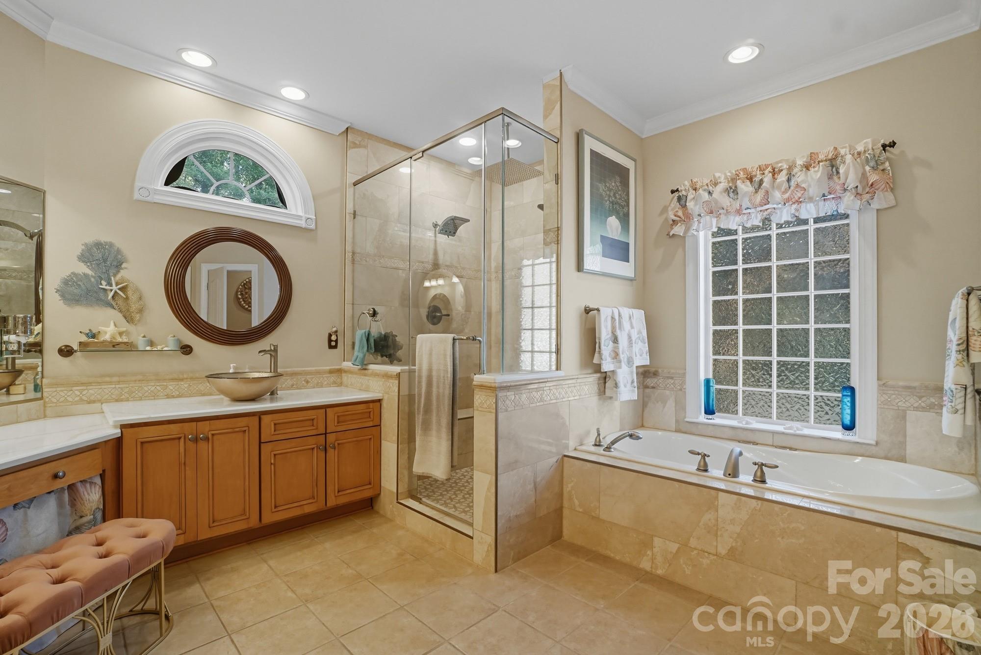 8629 Hayden Way Concord, NC 28025 - Photo 23 of 39 a spacious bathroom with a tub a sink and a large mirror