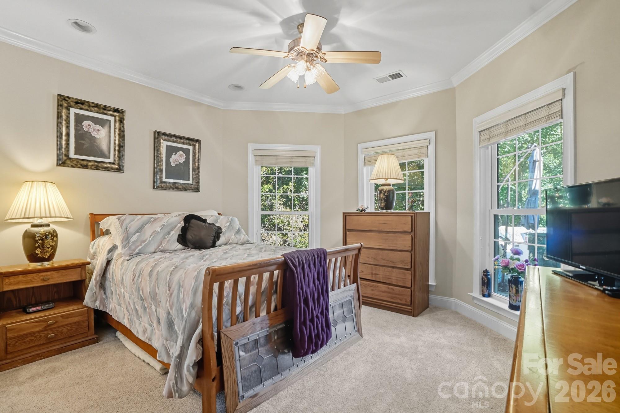 8629 Hayden Way Concord, NC 28025 - Photo 26 of 39 a bedroom with a bed and a flat screen tv