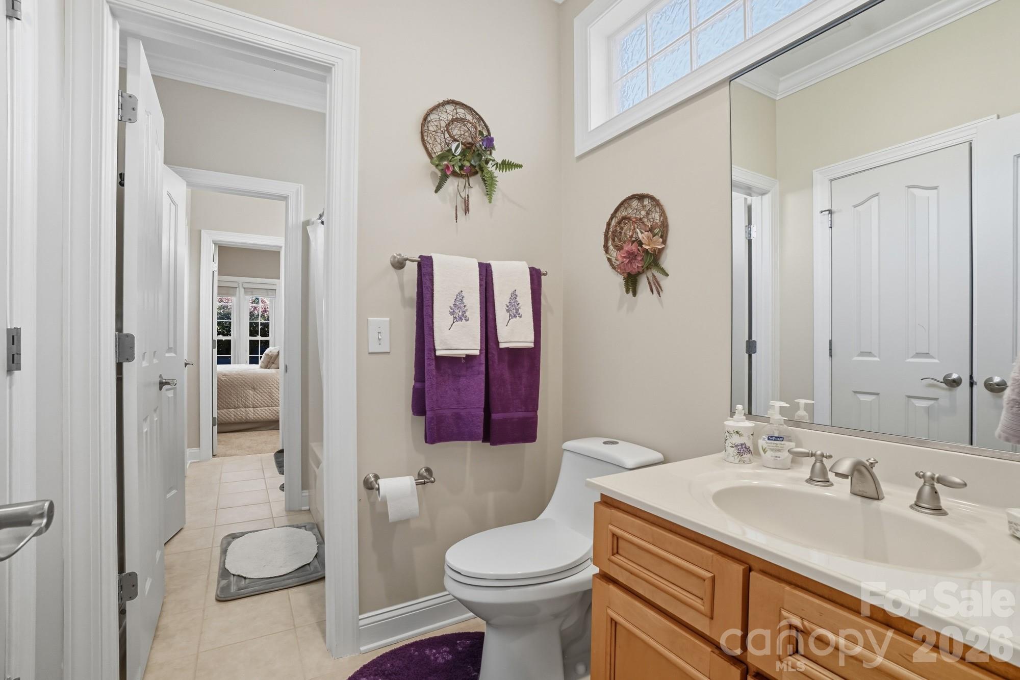 8629 Hayden Way Concord, NC 28025 - Photo 27 of 39 a bathroom with a granite countertop sink toilet and mirror