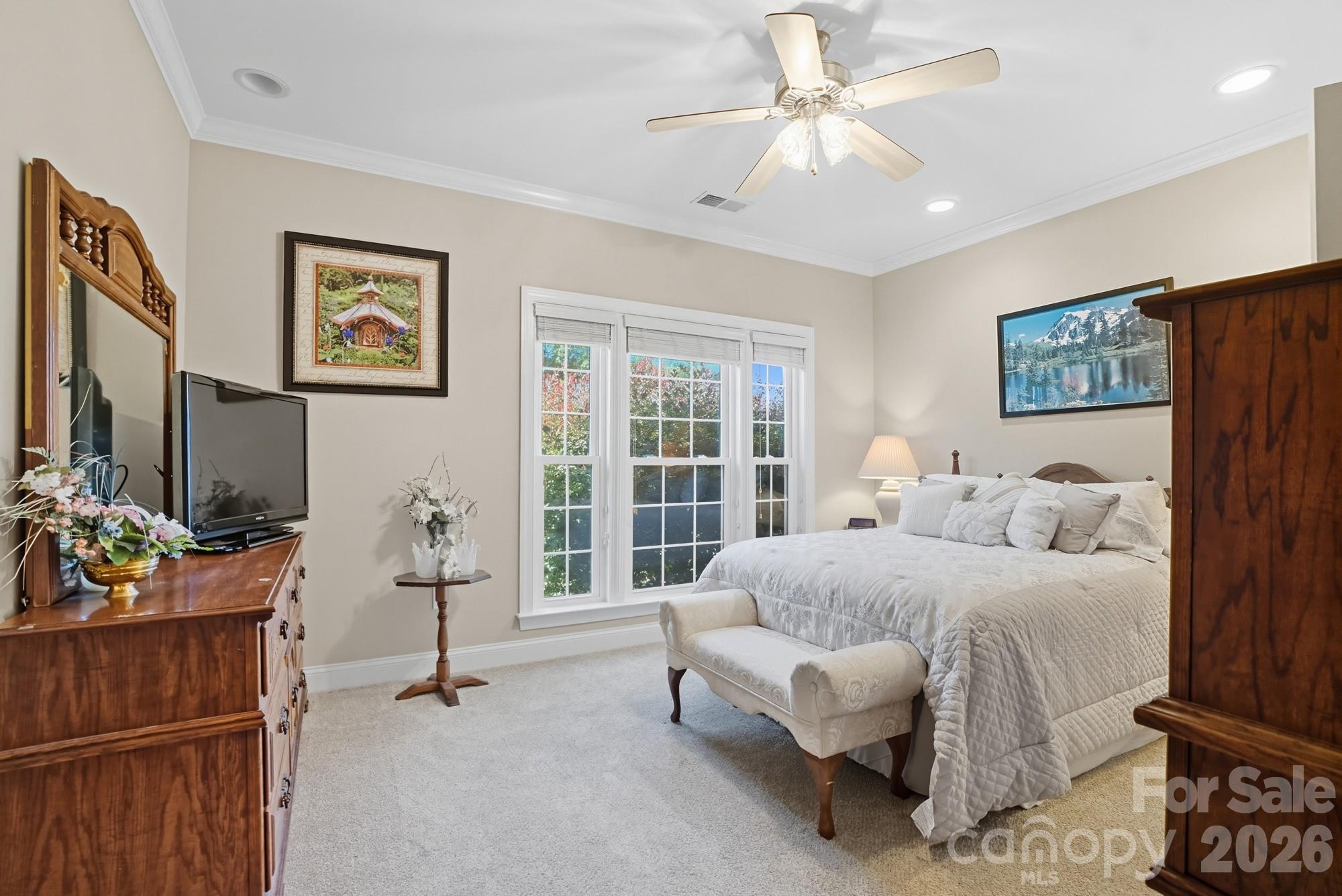 8629 Hayden Way Concord, NC 28025 - Photo 28 of 39 a bedroom with furniture and a large window