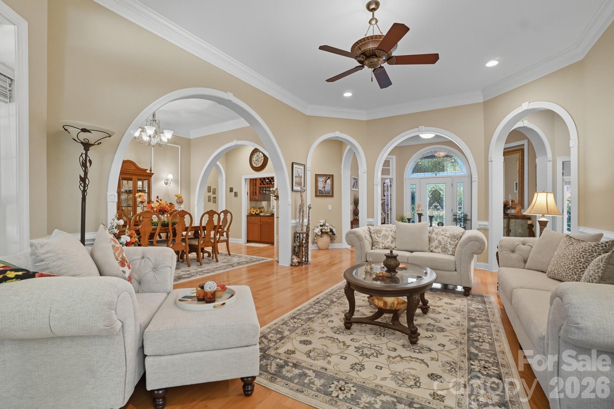 8629 Hayden Way Concord, NC 28025 - Photo 6 of 39 a living room with furniture a rug and a chandelier