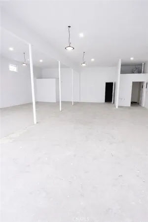 an empty room with a kitchen and a sink