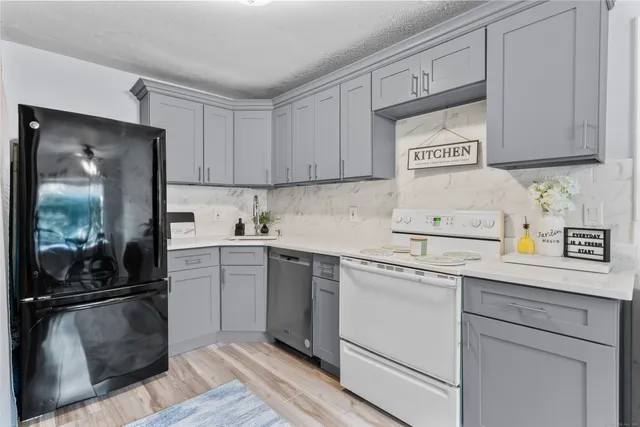 a kitchen with cabinets and stainless steel appliances