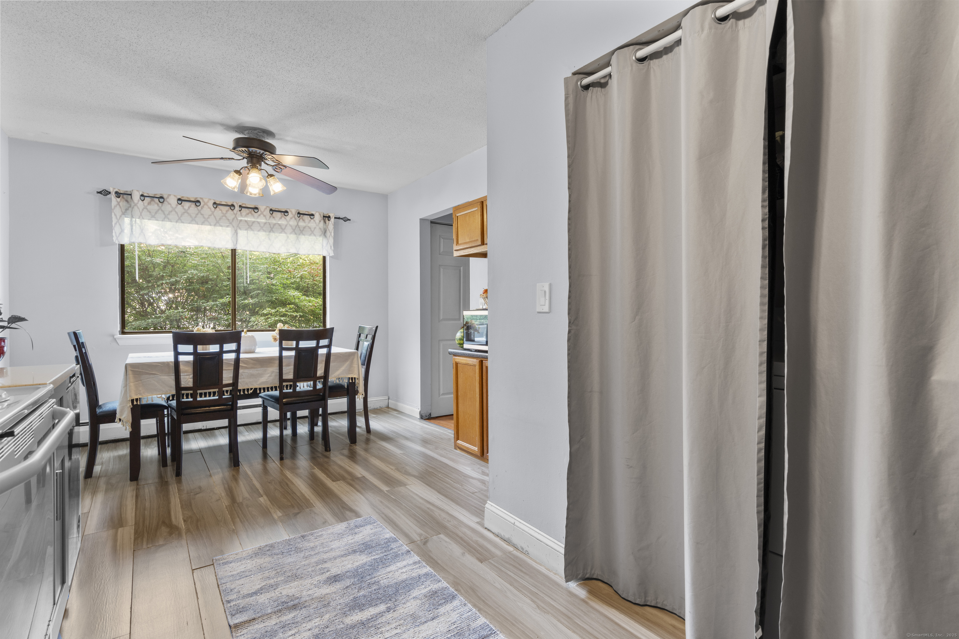203 Kaynor Drive, Unit B Waterbury, CT 06708 - Photo 12 of 36 a dining room with furniture window wooden floor