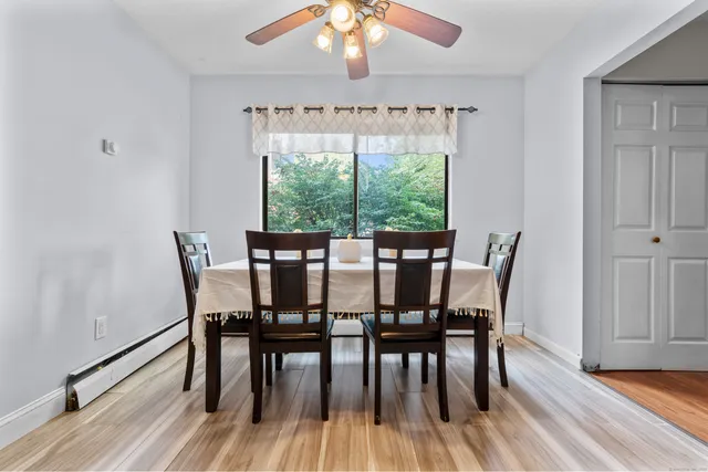 a view of a dining room with furniture window and wooden floor
