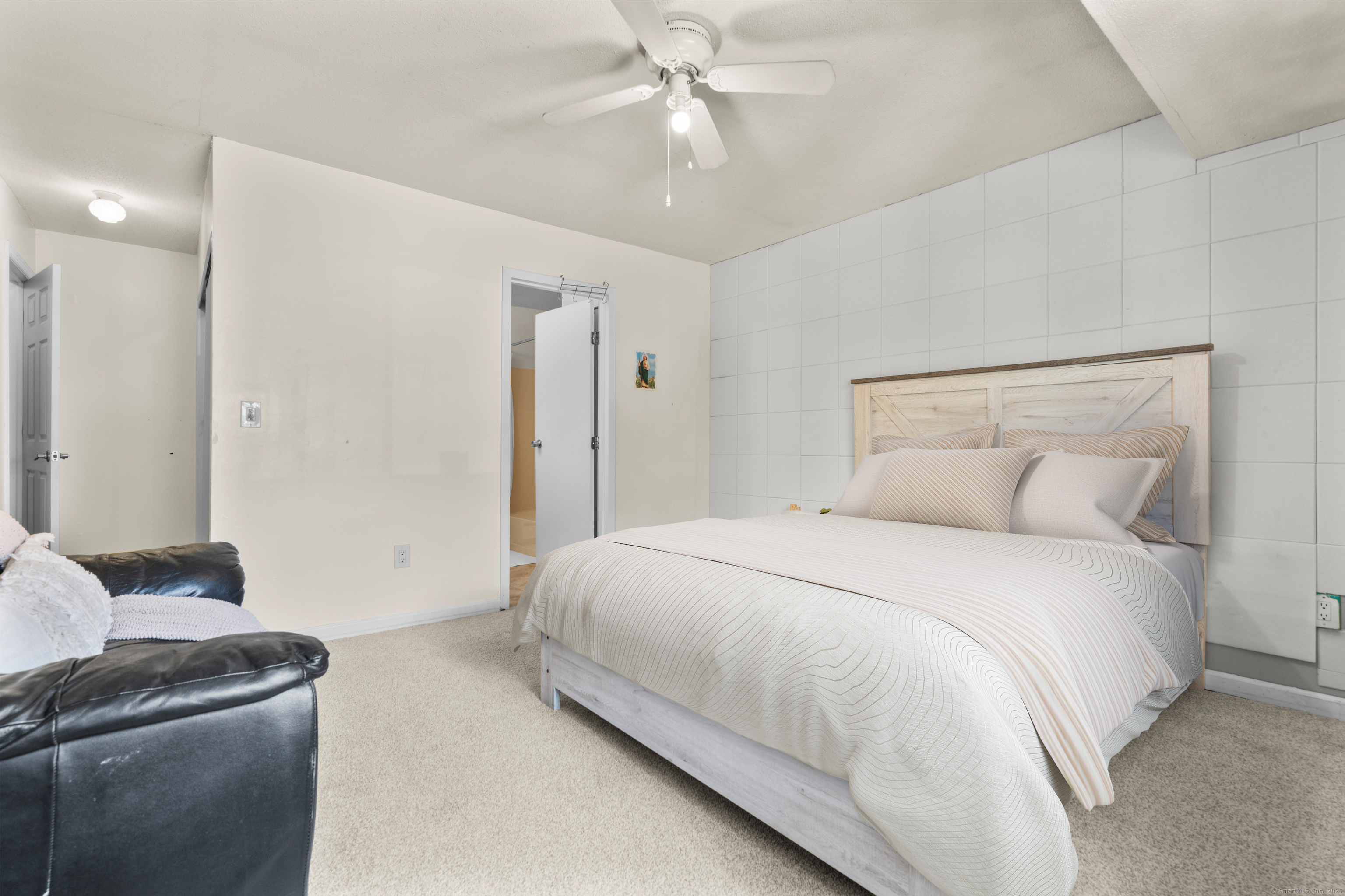 203 Kaynor Drive, Unit B Waterbury, CT 06708 - Photo 19 of 36 a bedroom with a bed and a chandelier