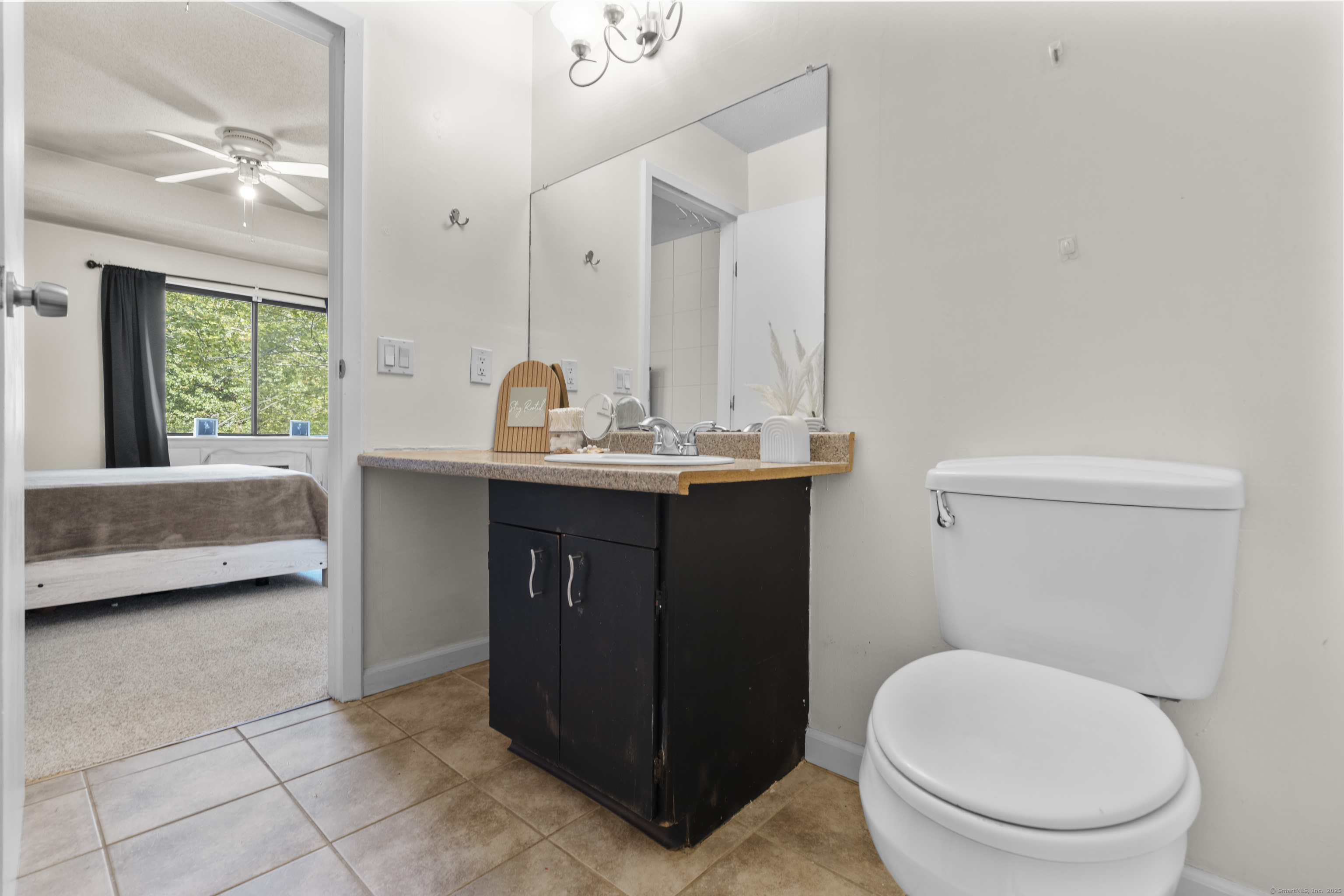 203 Kaynor Drive, Unit B Waterbury, CT 06708 - Photo 20 of 36 a bathroom with a sink a toilet and a mirror