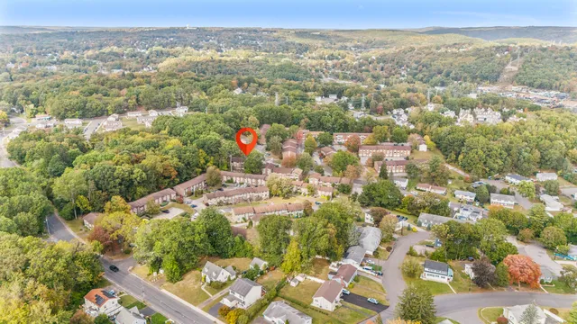 an aerial view of residential house with yard and mountain view in back