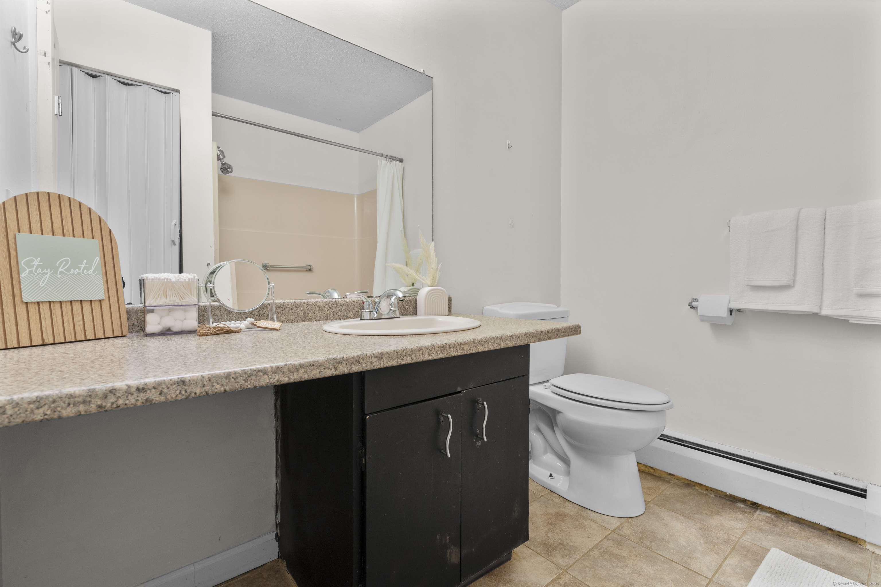 203 Kaynor Drive, Unit B Waterbury, CT 06708 - Photo 21 of 36 a bathroom with a granite countertop sink a toilet and a mirror