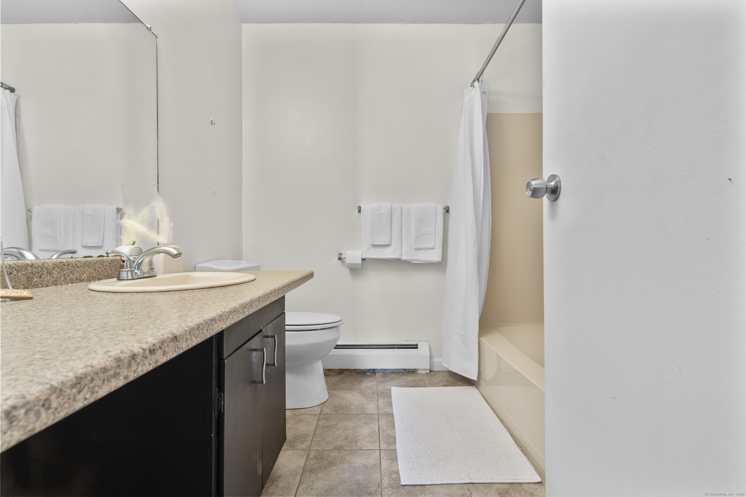 203 Kaynor Drive, Unit B Waterbury, CT 06708 - Photo 22 of 36 a bathroom with a sink a toilet and a mirror